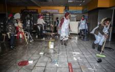 Alexandra community members cleaning up after days of looting that saw many shops and businesses vandalised. Picture: Abigail Javier/Eyewitness News.