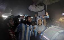 Fans of Argentine football star Lionel Messi rally under the rain asking for his return to the national team at the Obelisco in Buenos Aires on 2 July, 2016. Picture: AFP.