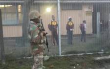 FILE: The army guard the street next to the school in Manenberg during an Operation Fiela raid in the area on 21 May 2015. Picture: @SAPoliceService.