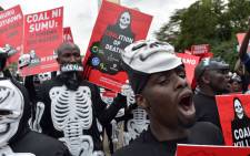 FILE: Activists march on 5 June 2018 in Nairobi carrying placards bearing messages to denounce plans by the Kenyan government to mine coal close to the pristine coastal archipelago of Lamu, on World Environment Day. Picture: AFP.
