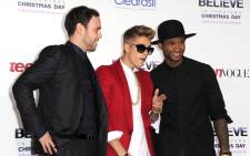 FILE: Producer Scooter Braun, singer/producer Justin Bieber and producer Usher arrive at the premiere Of Open Road Films’ "Justin Bieber’s Believe" at Regal Cinemas LA Live on 18 December, 2013 in Los Angeles, California. Picture: AFP.