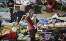 A girl holds her sibling in a temporary shelter for Ukrainian refugees in a school in Przemysl, near the Ukrainian-Polish border on March 14, 2022. The number of refugees fleeing Ukraine since the Russian invasion launched by President Vladimir Putin on February 24 is now nearly 2.7 million, the UN said on March 13, 2022.
Louisa GOULIAMAKI / AFP.
