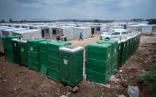 Portable bathrooms and shacks constructed for Usindiso building fire victims in Denver, south of Johannesburg, on 16 November 2023. Victims were relocated from a shelter, where they had been seeking refuge since the blaze gutted the hijacked building in August, and killed close to 80 people. Picture: Jacques Nelles/Eyewitness News