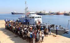 Illegal migrants from Africa stand in line at a naval base in Tripoli after being rescued by Libyan coastguards in the Mediterranean Sea off the Libyan coast on 29 August 2017. Picture: AFP