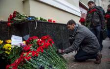 People lay flowers at the home stage building of the Alexandrov Ensemble (The Red Army Choir), in Moscow, on December 25, 2016, after a Russian military plane which included dozens of Red Army Choir members crashed. Picture: AFP