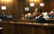 Paralympian Oscar Pistorius is seen during judgment in his murder trial at the High Court in Pretoria on Friday, 12 September 2014. Picture: Pool.