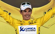 Daryl Impey celebrates his yellow jersey at the end of the sixth stage of the 100th edition of the Tour de France cycling race. Picture: AFP.