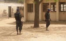 FILE: Policemen stand on guard at the premises of Government Girls Technical College, where 110 girls were kidnapped by Boko Haram Islamists at Dapchi town in northern Nigerian on 19 February 2018. Picture: AFP.