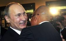 FILE: Russian President Vladimir Putin hugs South Africa President Jacob Zuma before a meeting at the BRICS summit in Durban on 26 March, 2013. Picture: AFP.