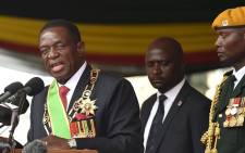 FILE: Zimbabwean new interim President Emmerson Mnangagwa (L) gives an address after he is officially sworn-in during a ceremony in Harare on 24 November 2017. Picture: AFP.