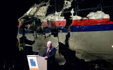Dutch Safety Board Chairman Tjibbe Joustra speaks in front of the wrecked cockpit of the Malaysia Airlines flight MH17 exhibited during a presentation of the final report on the cause of the its crash at the Gilze Rijen airbase 13 October, 2015. Picture: AFP.
