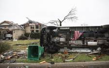 An American flag placed by first responders is seen 27 December, 2015 in the aftermath of a tornado in Rowlett, Texas. At least 11 people lost their lives as tornadoes tore through Texas, authorities said, as they searched home to home for possible more victims of the freak storms lashing the southern United States. Picture: AFP.