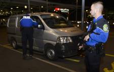 Security forces stop a van at the check vehicles arriving at Genevas airoport on 10 December, 2015, after police raised the alert level and searched the city for several suspected jihadists believed to have links to the Islamic State (IS) group, security sources said. Picture: AFP.