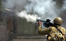 An Israeli soldier fires a tear gas canister during clashes.  Picture: Hazem Bader/AFP.