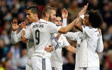FILE: Real Madrid's Karim Benzema celebrates with Ronaldo (L) and Marcelo (R) after scoring a goal against Liverpool on 4 november 2014. Picture: Real Madrid Facebook page.