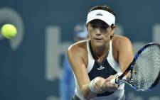This file photo taken on 6 January 2016 shows Garbine Muguruza of Spain hitting a return against Varvara Lepchenko of the US during their women's singles match on the fourth day of the Brisbane International tennis tournament. Picture: AFP. 