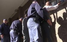 Police search pupils at Westbury Secondary High School in Johannesburg on 5 September, 2014. Picture: Vumani Mkhize/EWN.