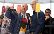 Apple chief design officer Jony Ive (L) and Apple CEO Tim Cook inspect the new iPhone XR during an Apple special event at the Steve Jobs Theatre on 12 September, 2018 in Cupertino, California. Picture: AFP