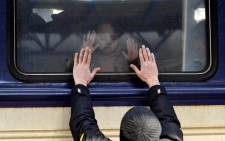 A man gestures in front of an evacuation train at Kyiv central train station on 4 March 2022.
