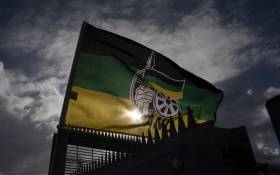 FILE: An ANC flag flies outside a polling station in Langa, near Cape Town, on 1 November 2021. Picture: AFP