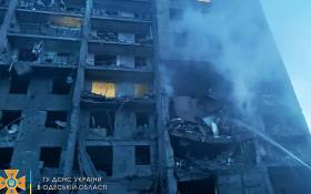 This handout picture taken and released by the Ukraine's State Emergency Service on 1 July 2022, shows a firefighter putting out the fire in a residents building hit by a missile strike in Ukrainian district of Bilhorod-Dnistrovskyi outside Odesa, killing at least 16 and 30 injuring. Picture: Handout / UKRAINE EMERGENCY MINISTRY PRESS SERVICE / AFP