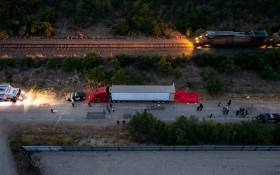 In this aerial view, members of law enforcement investigate a tractor trailer on June 27, 2022 in San Antonio, Texas. According to reports, at least 46 people, who are believed migrant workers from Mexico, were found dead in an abandoned tractor trailer. Picture: Jordan Vonderhaar/Getty Images/AFP