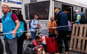 People evacuated from Mariupol's Azovstal plant arrive on buses at a registration and processing area for internally displaced people in Zaporizhzhia on 3 May 2022. The UN says 101 civilians have been "successfully evacuated" from Ukraine's besieged and battered port city of Mariupol in a joint effort with the Red Cross. Picture: Dimitar DILKOFF/AFP