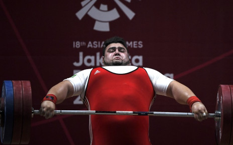 FILE: Pakistan's Mohammad Nooh Dastgir Butt attempts a lift during the men's +105kg weightlifting event at the 2018 Asian Games in Jakarta. Picture: AFP
