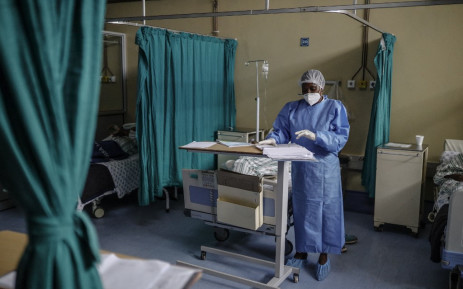 FILE: Nurse Salome Nkoana, acting operational manager of COVID-19 ward at the Tembisa Hospital, checks the history of a patient infected with COVID-19 in Tembisa, on March 2, 2021. Picture: Guillem Sartorio / AFP