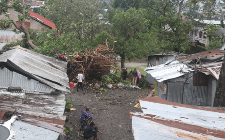 FILE: People stand by damaged houses and fallen trees on April 25, 2019 in Moroni after tropical storm Kenneth hit Comoros before heading to recently cyclone-ravaged Mozambique. Picture: AFP.