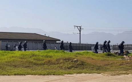 Police on the scene of a land invasion in Somerset West. Picture: @senkamin/Twitter