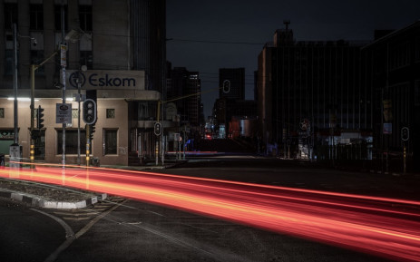 Trails of lights from passing vehicles in Braamfontein, Johannesburg while the area is submerged in darkness due to load shedding. Picture: AFP
