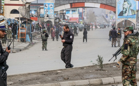 FILE: Afghan security forces personnel stand guard on a road near the site of a gun attack that occurred during an event ceremony to mark the 25th anniversary of the death of Shiite leader Abdul Ali Mazari, in Kabul on 6 March 2020. Picture: AFP