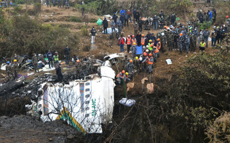 Rescuers pull the body of a victim who died in a Yeti Airlines plane crash in Pokhara on 16 January 2023. Nepal observed a day of mourning on 16 January for the victims of the nation's deadliest aviation disaster in three decades, with 67 people confirmed killed in the plane crash. Picture: PRAKASH MATHEMA/AFP