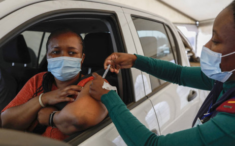 FILE: A woman receives a dose of the Johnson and Johnson COVID-19 vaccine from a healthcare worker at the Zwartkops Raceway in Centurion on 13 August 2021. Picture: Phill Magakoe/AFP