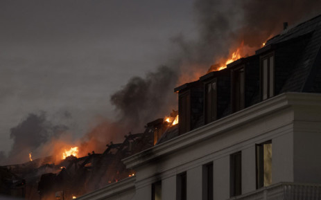 FILE: Flames arise from the National Assembly, the main chamber of the South African Parliament buildings, after a fire that broke out the day before restarted, in Cape Town, on 3 January 2022. Picture: RODGER BOSCH/AFP