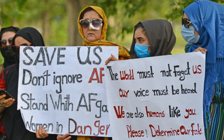 Afghans hold placards as they gather to demand help from the United Nations High Commissioner for Refugees for asylum abroad, in Islamabad on 12 May 2022.