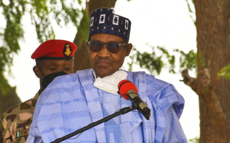 FILE: Nigerian President Muhammadu Buhari speaks during a visit to the Maimalari Barracks in Maiduguri on 17 June 2021. Picture: Audu Marte/AFP