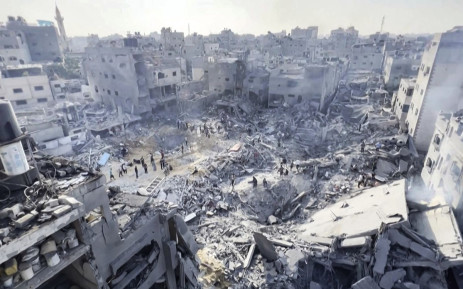 This image grab taken from AFPTV video footage shows Palestinians checking the destruction in the aftermath of an Israeli strike on the Jabalia refugee camp in the Gaza Strip, on 1 November 2023, amid ongoing battles between Israel and the Palestinian Hamas movement. Picture: AFP
