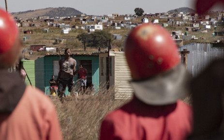 The Red Ants (foreground) confront residents of the Lakeview informal settlement near Ennerdale on 21 April 2020 after they were evicted by by the City of Joburg. Picture: Sethembiso Zulu/EWN