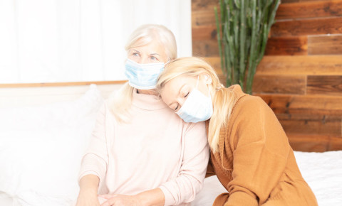Senior old woman with daughter surgical face masks at home 123rf
