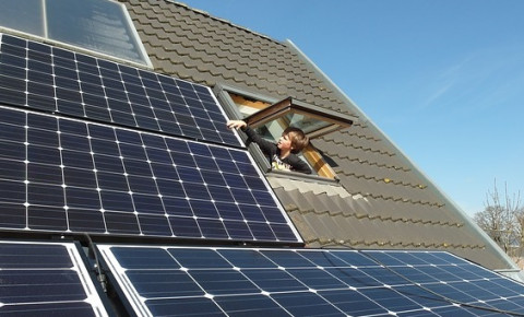 boy-looking-at-solar-panels-on-roofjpg
