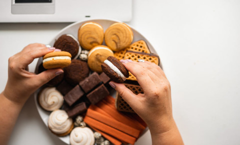 Woman snacking sweets treats biscuits junk food diet diabetes health 123rf