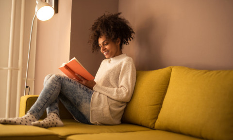 Young woman reading a book at home 123rf