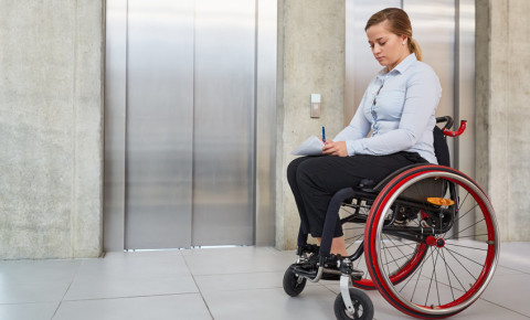 Disabled woman wheelchair elevator office company disability diversity 123rf