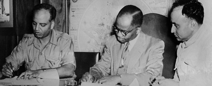 FILE: From L to R : Doctors GM Naicker, known as Monty Naicker, President of the Natal Indian Congress, Alfred Bitini Xuma, President of the ANC and Yusuf Mohamed Dadoo, President of the Transvaal Indian Congress sign, 9 March 1947, the historic pact of cooperation between the ANC and the Indian Congresses, consolidating the spirit of fraternity and solidarity between the African and Indian communities in South Africa. Picture: AFP