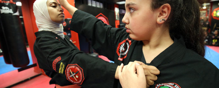 FILE: Kuwaiti Asma Hasnawi (L), a Kajukenbo hybrid martial art assistant-master, practises with her daughter Riham, in a club in Kuwait City on 22 October 2018. Picture: AFP
