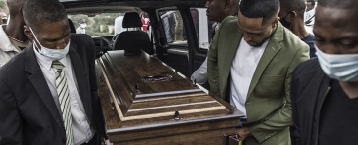 FILE: The coffin containing the remains of Njabulo Allen Dlamini (31) a father of 11, arrives on 21 July 2021 for a funeral service at his home. The taxi driver was killed in Phoenix, Durban, on 12 July, allegedly by a group of South African Indian residents manning a roadblock while defending their properties from looters. Picture: MARCO LONGARI/AFP