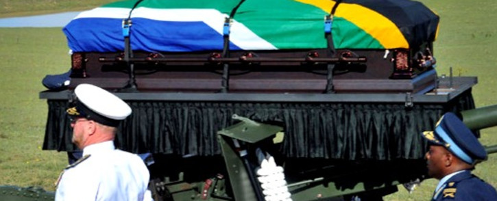 Nelson Mandela's casket is carried by military and police members on a gun carriage during his funeral service in Qunu, Eastern Cape, on 15 December 2013. Picture: GCIS