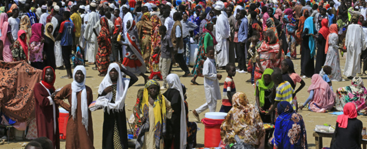 FILE: Displaced Sudan nationals queue to receive humanitarian aid supplies at the Kalma camp for internally displaced people in Darfur's state capital Niyala in October 2019. Picture: AFP.